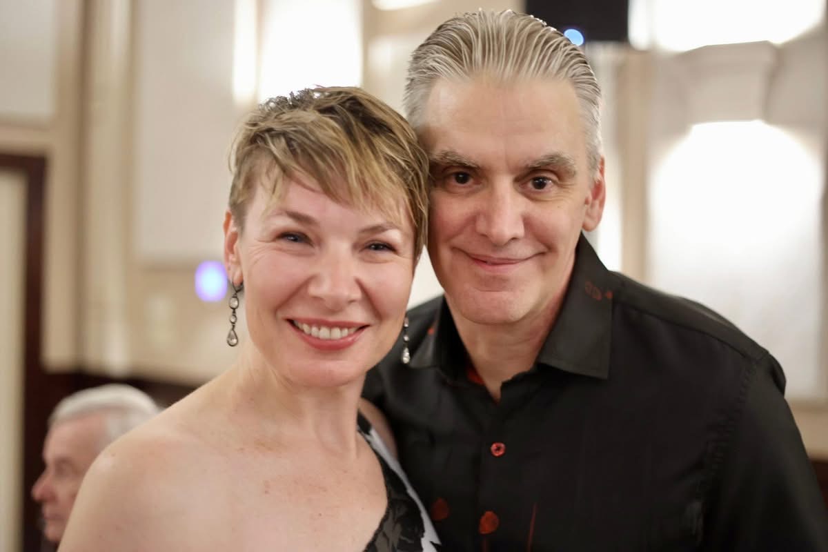 Tango partners smiling after a dance